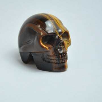 Craniu de cristal sculptat manual cu ochi de tigru pentru decorarea casei